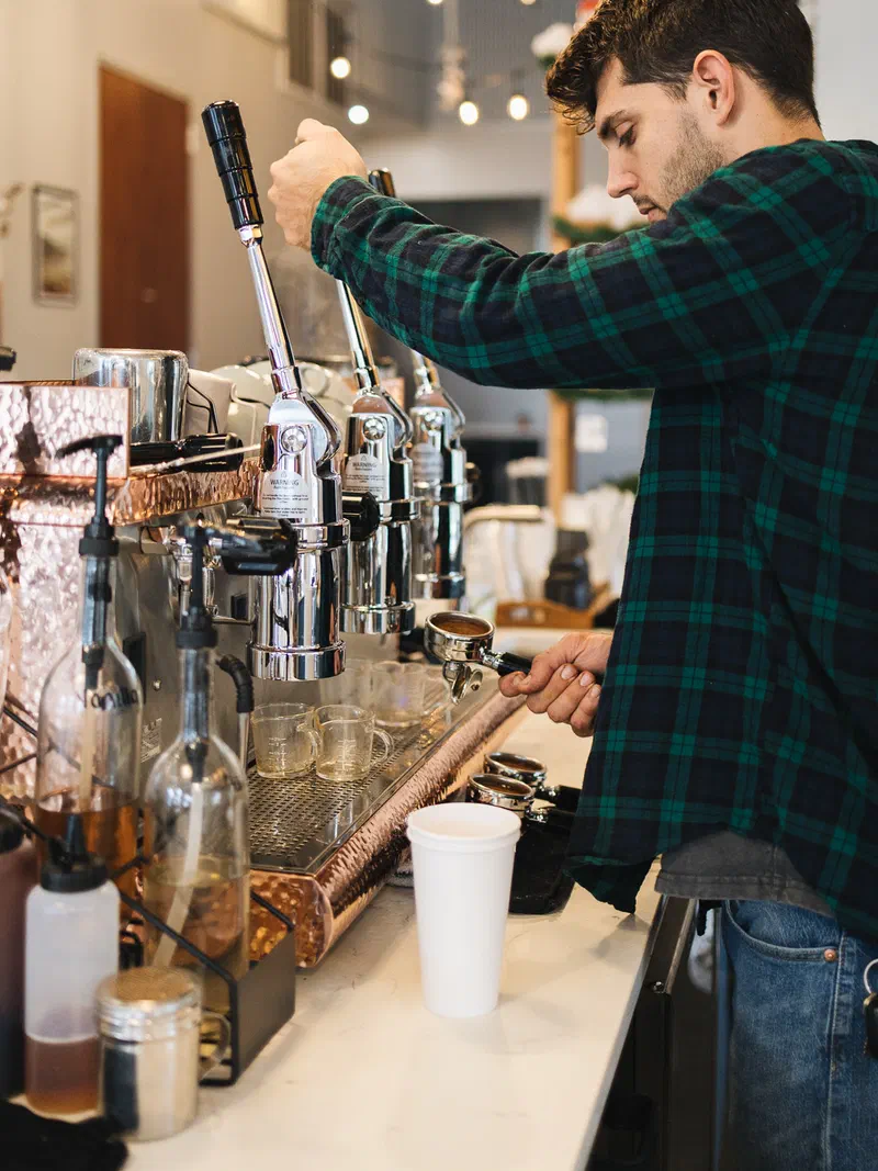 A barista pulling a shot of espresso at Sycamore